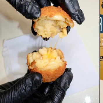 A Fri Kitchn macaroni ball broken open to show the filling.