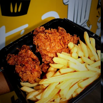 A Fri Kitchn takeaway box of fried chicken with french fries.